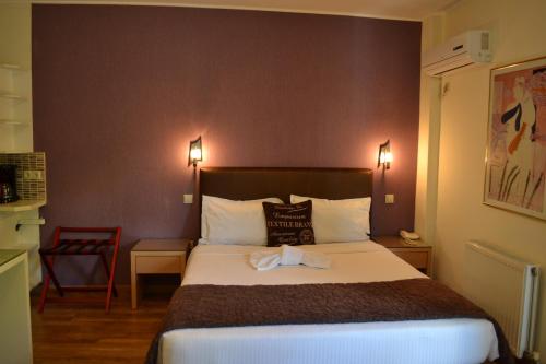 a hotel room with a bed with a towel on it at Rivitel Marousi Apartments in Athens