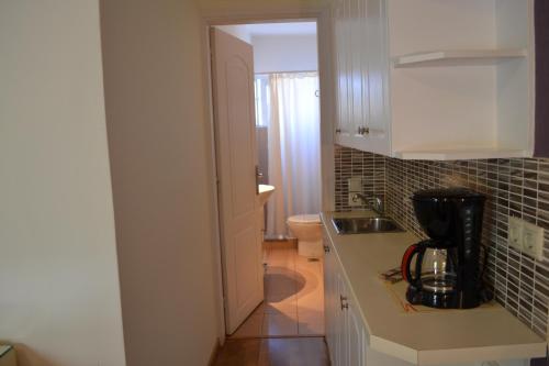 a kitchen with a counter with a blender on it at Rivitel Marousi Apartments in Athens