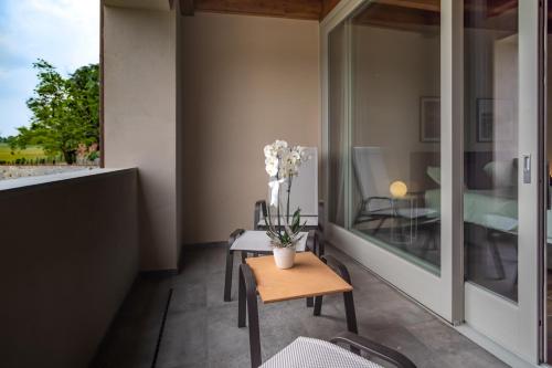 a balcony with a table with flowers on it at Borgo di Drugolo in Lonato del Garda