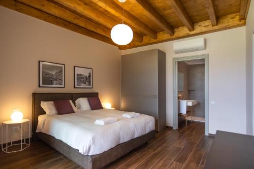 a bedroom with a bed with two lamps and a table at Borgo di Drugolo in Lonato del Garda