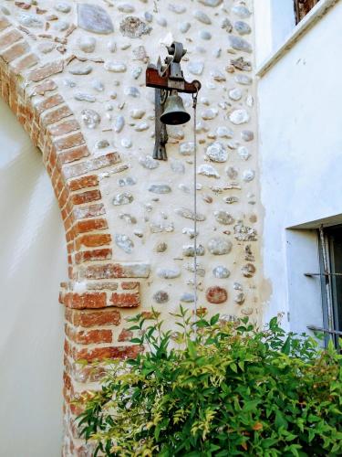 a light on the side of a building with a stone wall at Cà Romi in Volta Mantovana