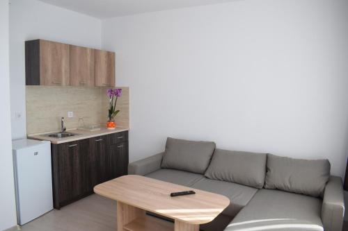 a living room with a couch and a table at Къща за гости Шошови in Velingrad