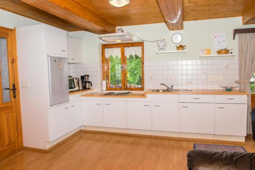 a kitchen with white cabinets and a window at Family House Dolni Lanov in Dolní Lánov
