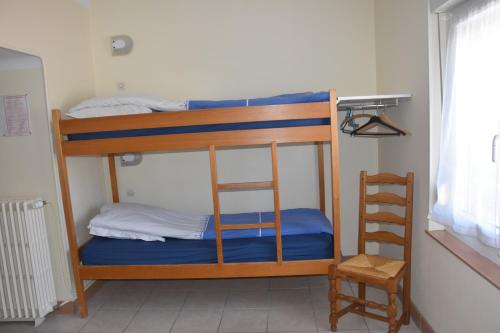two bunk beds in a room with a ladder at Hotel Gai Relais in Gérardmer