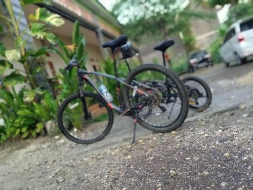 two bikes parked on the side of a street at Griya PAS Pangandaran in Pangandaran
