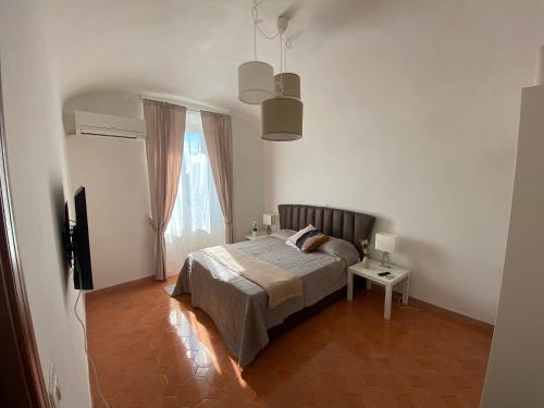 a bedroom with a bed and a television and a window at Campani apartment in Rome
