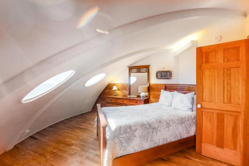 a bedroom with a bed and an attic at Dome Home in Indian Pass