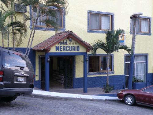 a hotel mexican restaurant with palm trees in front of a building at Hotel Mercurio - Gay Friendly in Puerto Vallarta