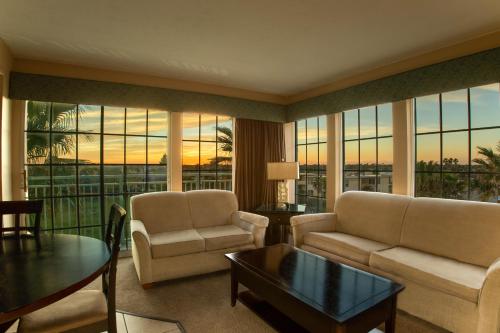 a living room with a couch and chairs and a table at Sea Shells Beach Club in Daytona Beach