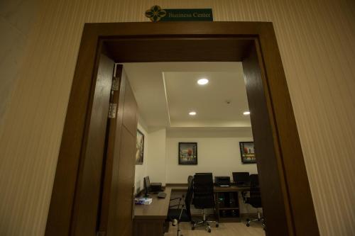 an open door to a office with a desk and chairs at Fiori Hotel in Erbil