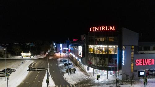 a city street at night with a sign on a building at Centrum Hotel Viljandi in Viljandi