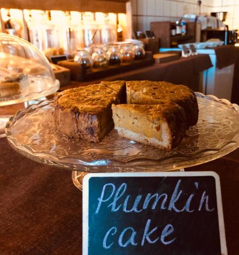 a plate with a piece of pumpkin cake on a table at Narcisa Farmhouse B&B in Nadur