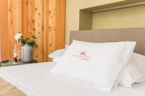 a white pillow sitting on top of a bed at Hotel Penzion Kobala in Tolmin