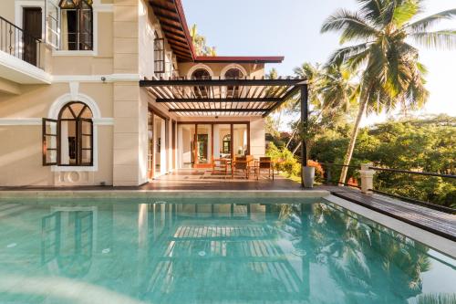 a villa with a swimming pool and a house at Villa Merak, Digana in Digana