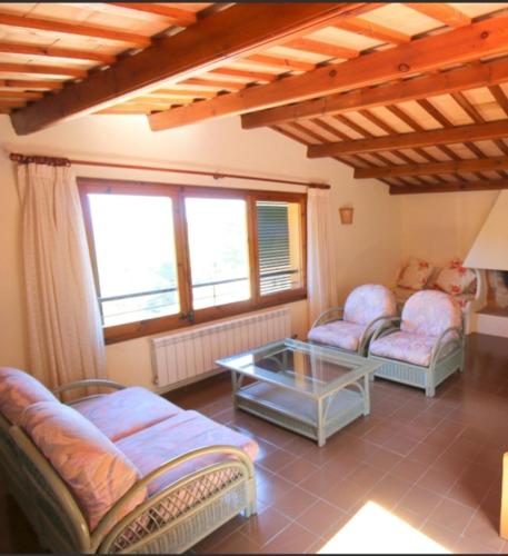 a living room with two couches and a table at Casa la Borna in Begur