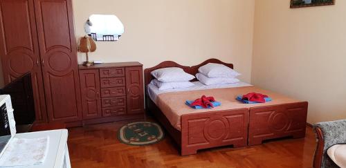 a bedroom with a bed with towels and a dresser at Hercules in Truskavets