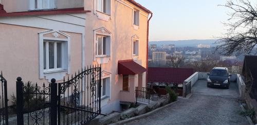 a car parked on a street next to a house at Hercules in Truskavets