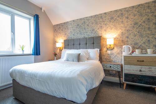Un pat sau paturi într-o cameră la Rickerby Grange