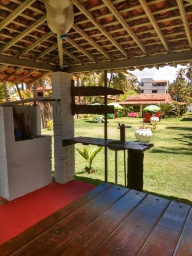 a patio with a table in a yard at Parador Algaroba in Japaratinga