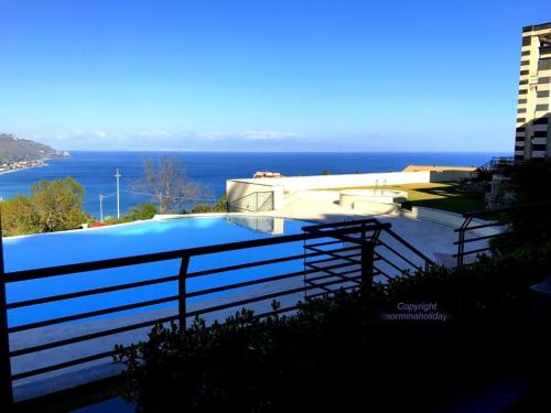 a swimming pool on a balcony with a view of the ocean at Taormina Lux & Elite Apartments - Taormina Holidays in Taormina
