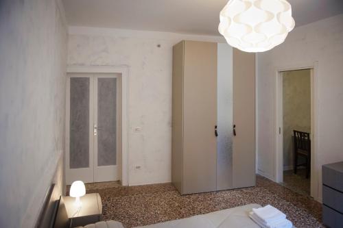 a bedroom with a bed and a chandelier at Porta Orientalis Venice in Venice