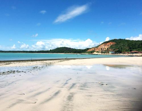 a beach with a reflection of the sky in the water at Parador Algaroba in Japaratinga