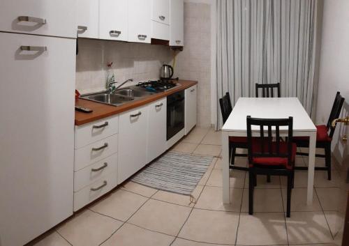 a kitchen with a white refrigerator and a table with chairs at Locazione Menini - Camere zona stazione in Padova