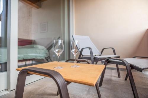 two wine glasses sitting on a table in a room at Borgo di Drugolo in Lonato del Garda