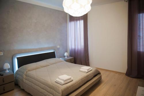 a bedroom with a bed and a chandelier at Porta Orientalis Venice in Venice