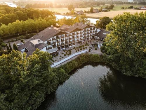 an aerial view of a hotel on a lake at Best Western Premier Seehotel Krautkrämer in Münster