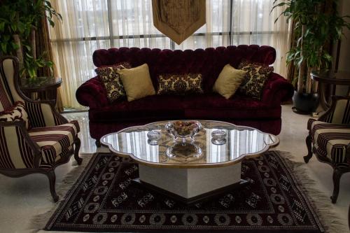 a living room with a couch and a coffee table at Fiori Hotel in Erbil