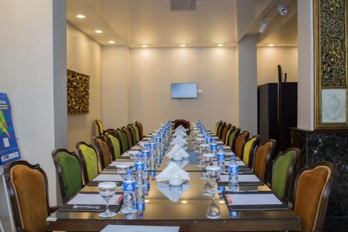 a long boardroom with a long table and chairs at Fiori Hotel in Erbil