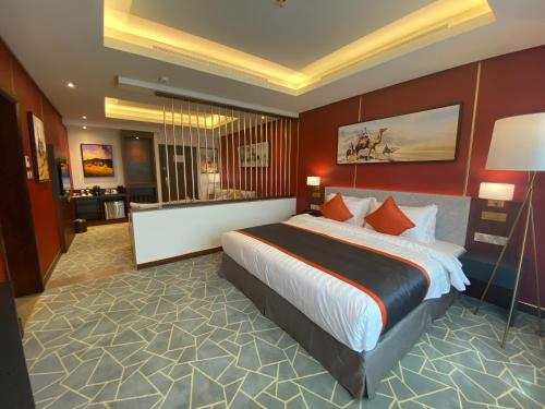 a hotel room with a large bed and a bathroom at Velar Inn Hotel in Taif