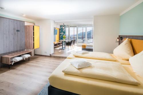 a hotel room with two beds and a dining room at Waldhotel Sonnenberg in Bollendorf