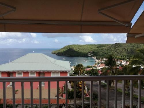 a view of the ocean from a balcony at Rose phoenix appartement terrasse et piscine vue mer in Les Anses-dʼArlets