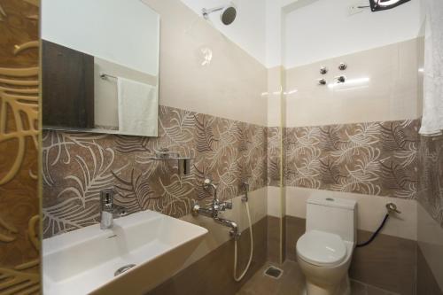 a bathroom with a sink and a toilet at Balaji residency in Chennai
