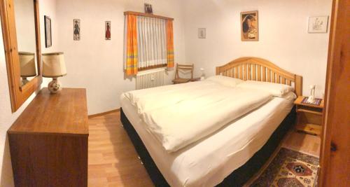 a bedroom with a large bed and a table at Chesa Panorama in Celerina