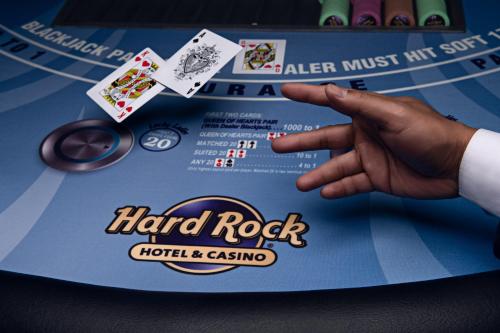 a person points to a hard rock poker table at Hard Rock Hotel & Casino Atlantic City in Atlantic City