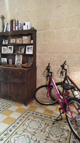 two bikes parked in a room with a book shelf at Ta’ Lorenzo in San Lawrenz