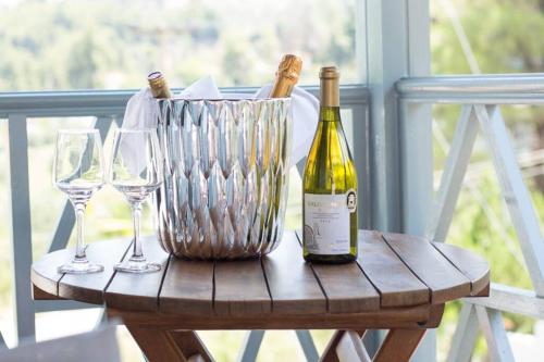 a bottle of wine and two wine glasses on a table at Casa Villa, Xenia Paliouri in Paliouri