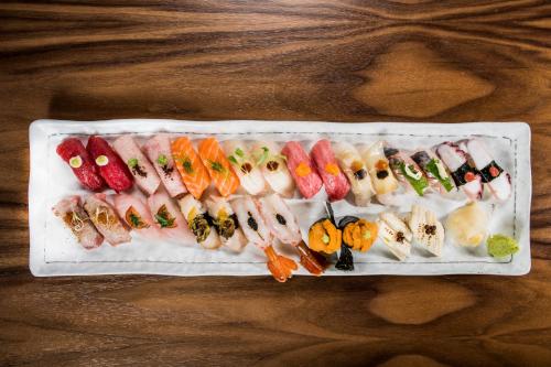 a tray of sushi and vegetables on a wooden table at Hard Rock Hotel & Casino Atlantic City in Atlantic City