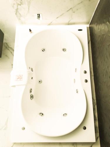 a white toilet in a box in a bathroom at Ramë Hotel Boutique in Guadalajara