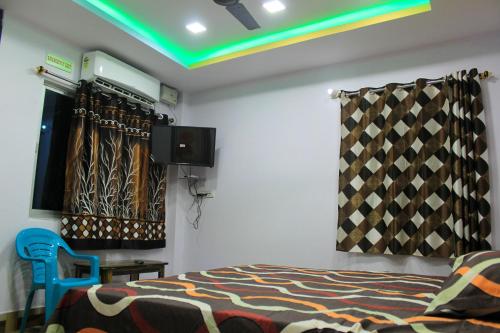 a bedroom with a bed and a tv in a room at PG Homes in Port Blair