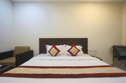 a bedroom with a large bed with two pillows at Balaji residency in Chennai