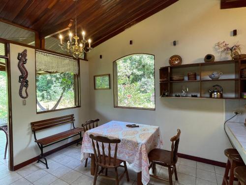 a kitchen and dining room with a table and chairs at Finca Isla Rainforest Retreat in Aguas Zarcas