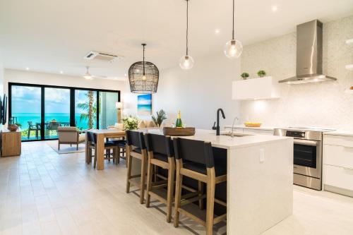 a kitchen and dining room with a table and chairs at H2O LifeStyle Resort in Long Bay Hills