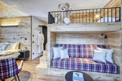 a living room with a couch with a teddy bear at Hotel Sant'Orso - Mountain Lodge & Spa in Cogne