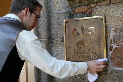 a man in a tuxedo looking at a sign at Longueville Manor in Saint Helier Jersey