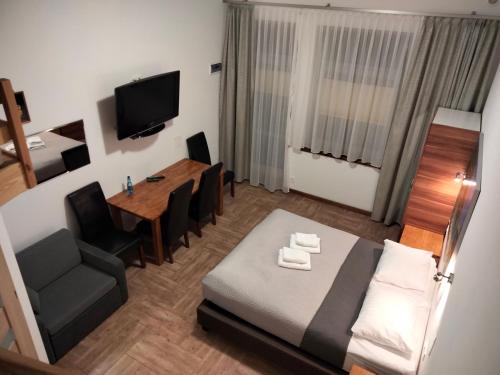 a small room with a bed and a dining table at Apartamenty Plażowa 11 in Darłówko