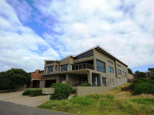 a large house on the side of a road at Whalesong Villa in Hermanus
